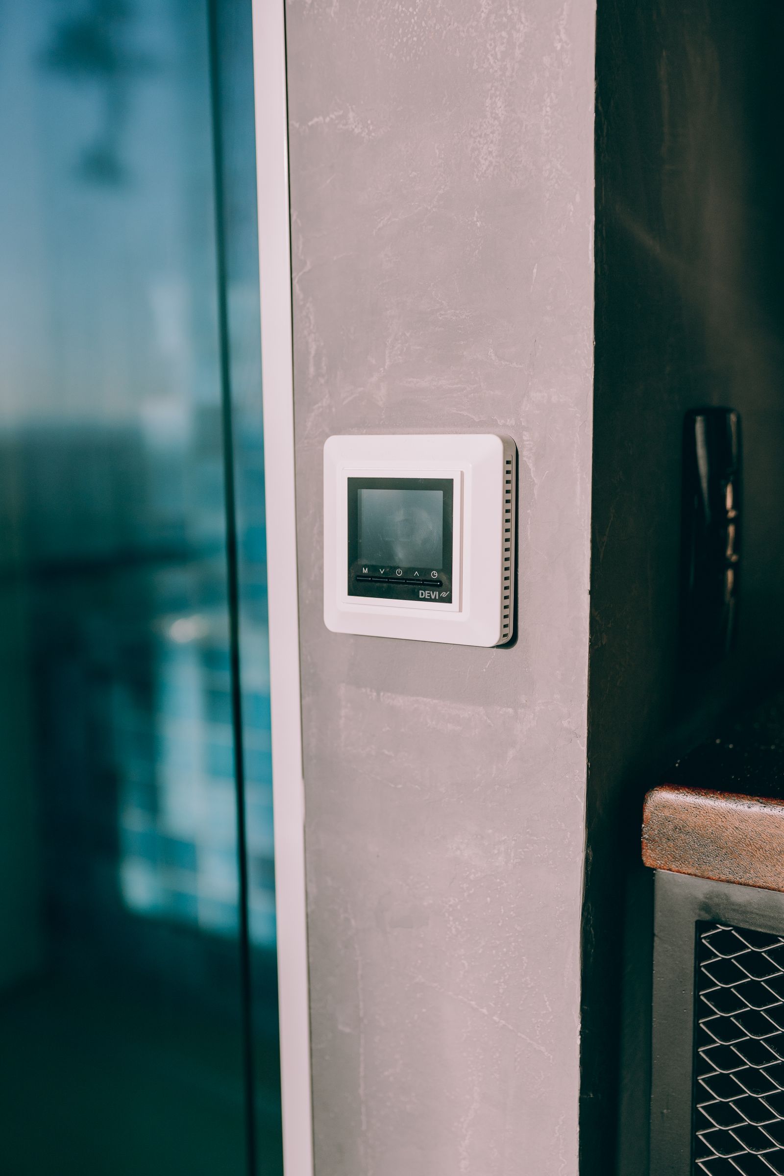 Digital thermostat on an interior wall