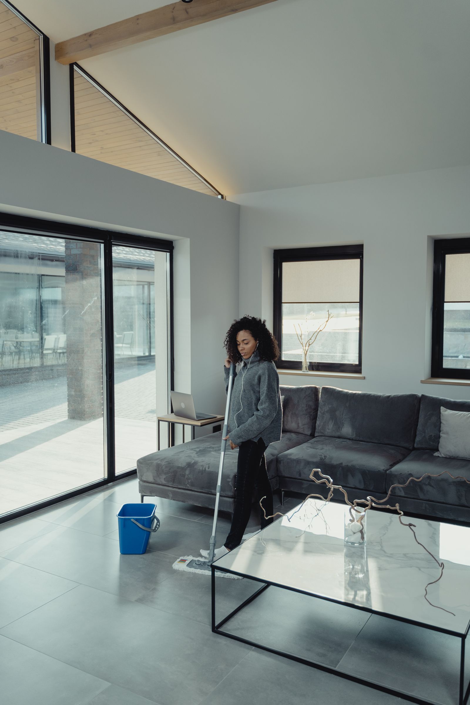 Woman mopping a modern living room